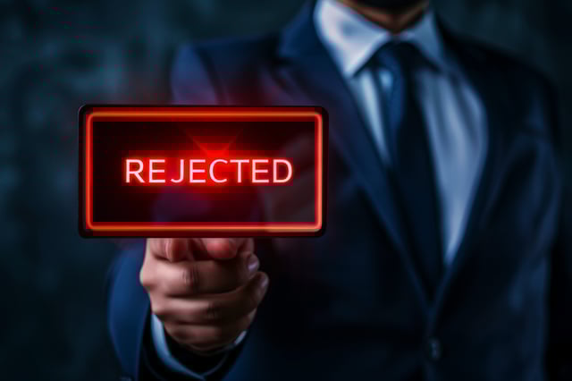 A Businessman In A Dark Blue Suit Points