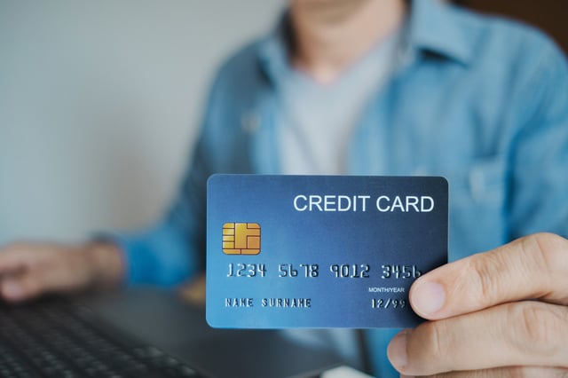 Close Up Man Holding Credit Card While Using Laptop Shopping Online Buying On Internet