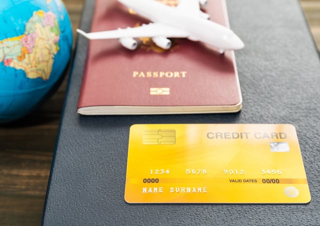 Credit Card And Airplane Model On Wooden Table
