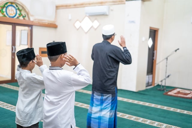 Father And Sons Inside A Mosque And Praying