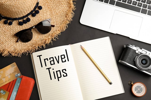 Flat Lay Composition With Tourist Items And Notebook On Black Background