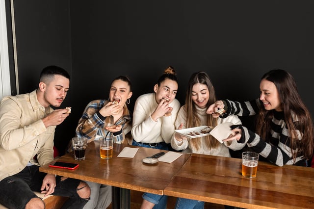 Friends eating with right hand together Friends eating with right hand together