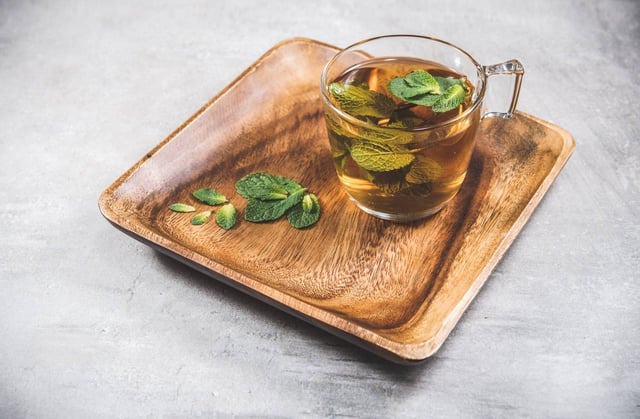 Glass of mint tea with leaves