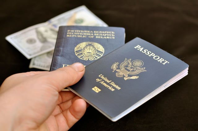 Hand With A Passport Of A Citizen Of The Usa