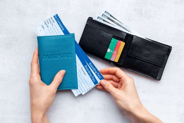 Hands Holding Passport With Tickets