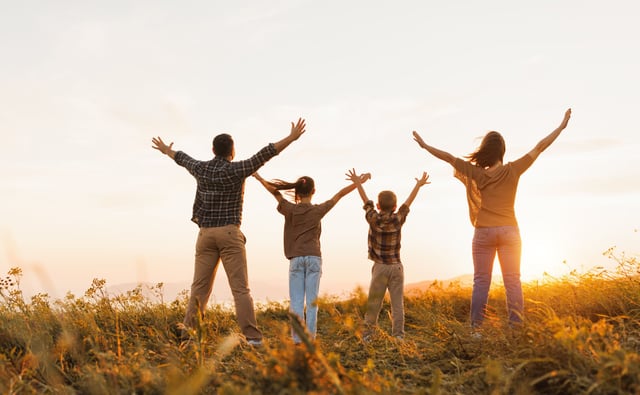 Happy family at sunset