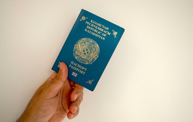 Kazakhstan Passport In A Man's Hand