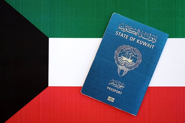 Kuwaiti Passport On Flag