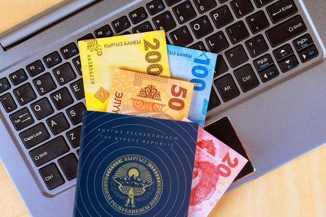 Money Of Various Denominations From Kyrgyzstan Over Keyboard