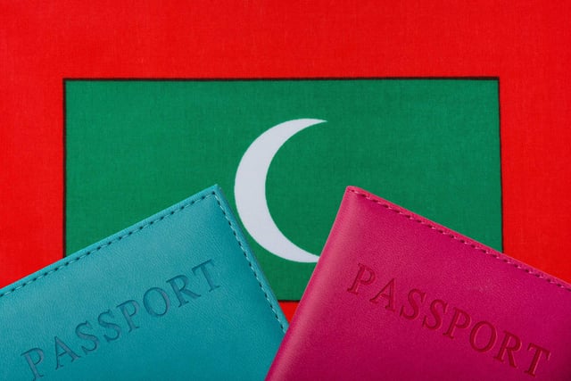 On The Background Of The Flag Of Maldives Two Passports