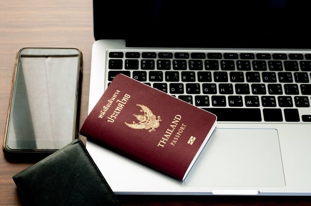 Open Laptop With Digital Smartphone Wallet And Passport Isolated