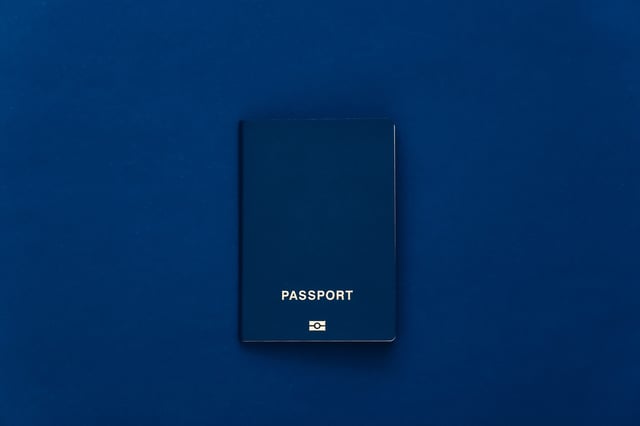 Passport On Classic Blue Background Top View