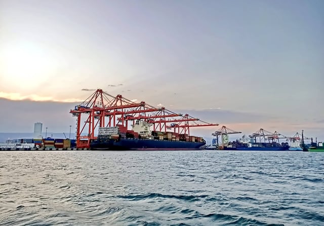 Sunset Occurring At A Port With Ships
