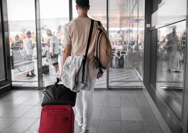 Traveller With Luggage During Airport Transit