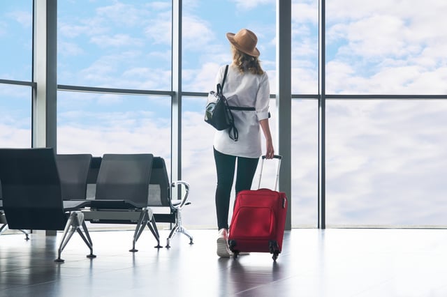 Woman Traveler Looking At The Sky Outside The Airport