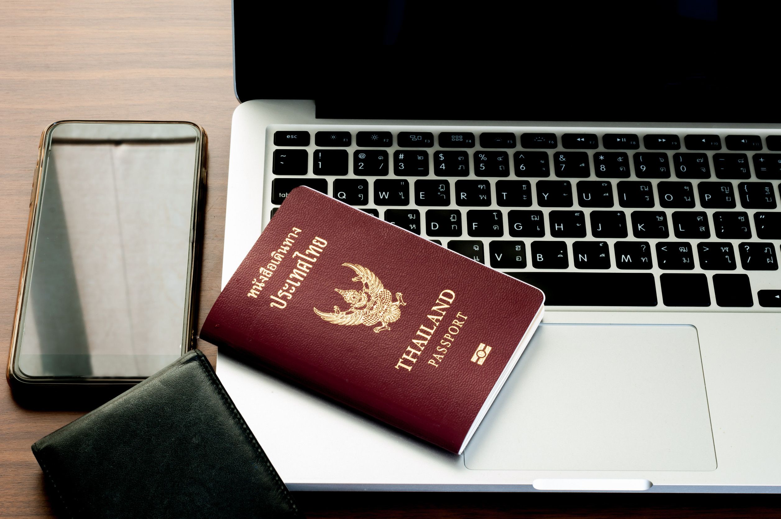 Open Laptop With Digital Smartphone Wallet And Passport Isolated