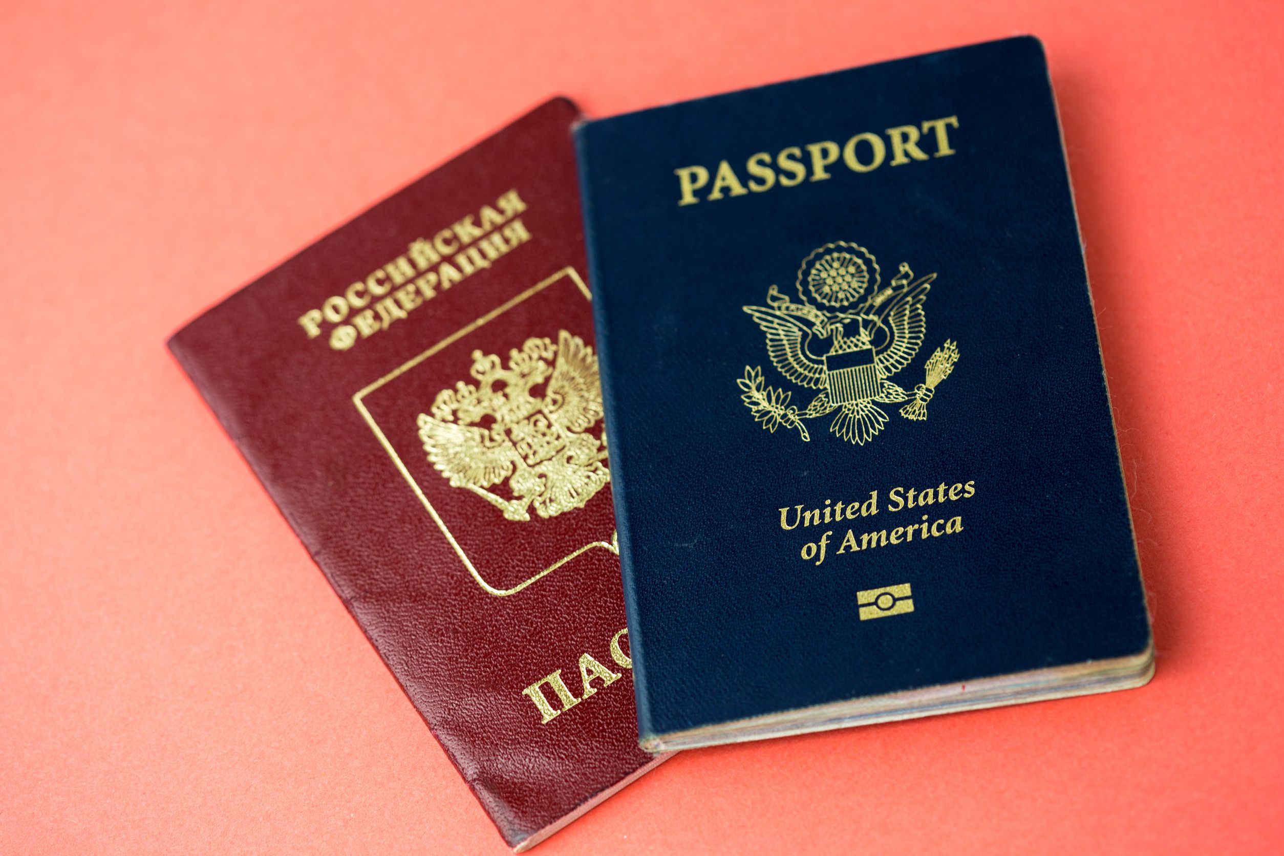 United States Passport Arranged On Top Of A Russian Passport
