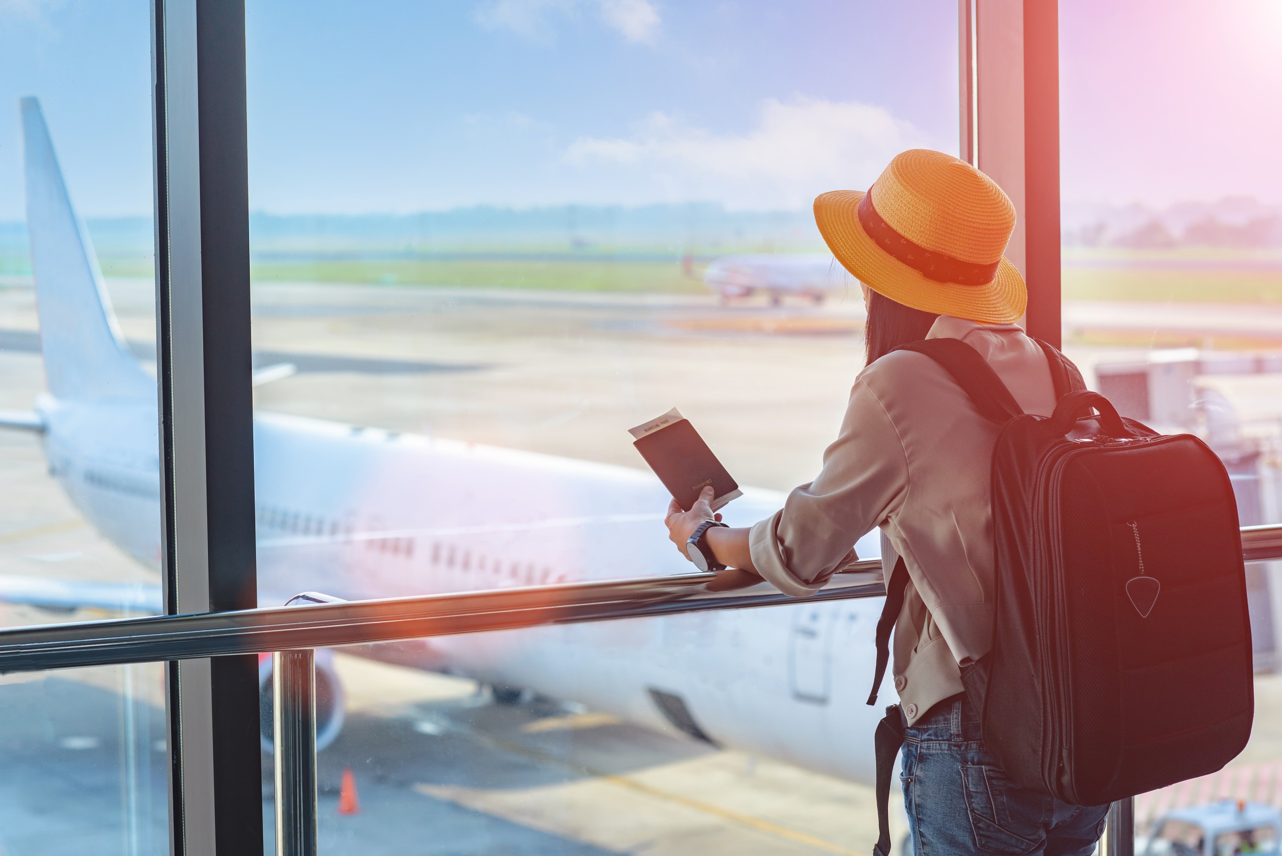 Woman Traveller Holding Passport Waiting In Transit Area Of Airport